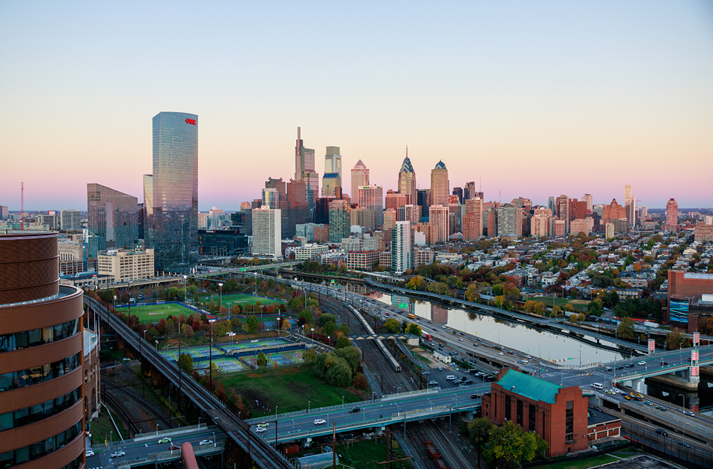 The city skyline of Philadelphia at sunset, as seen from an aerial location on the Penn Medicine campus with the Pavilion in the foreground